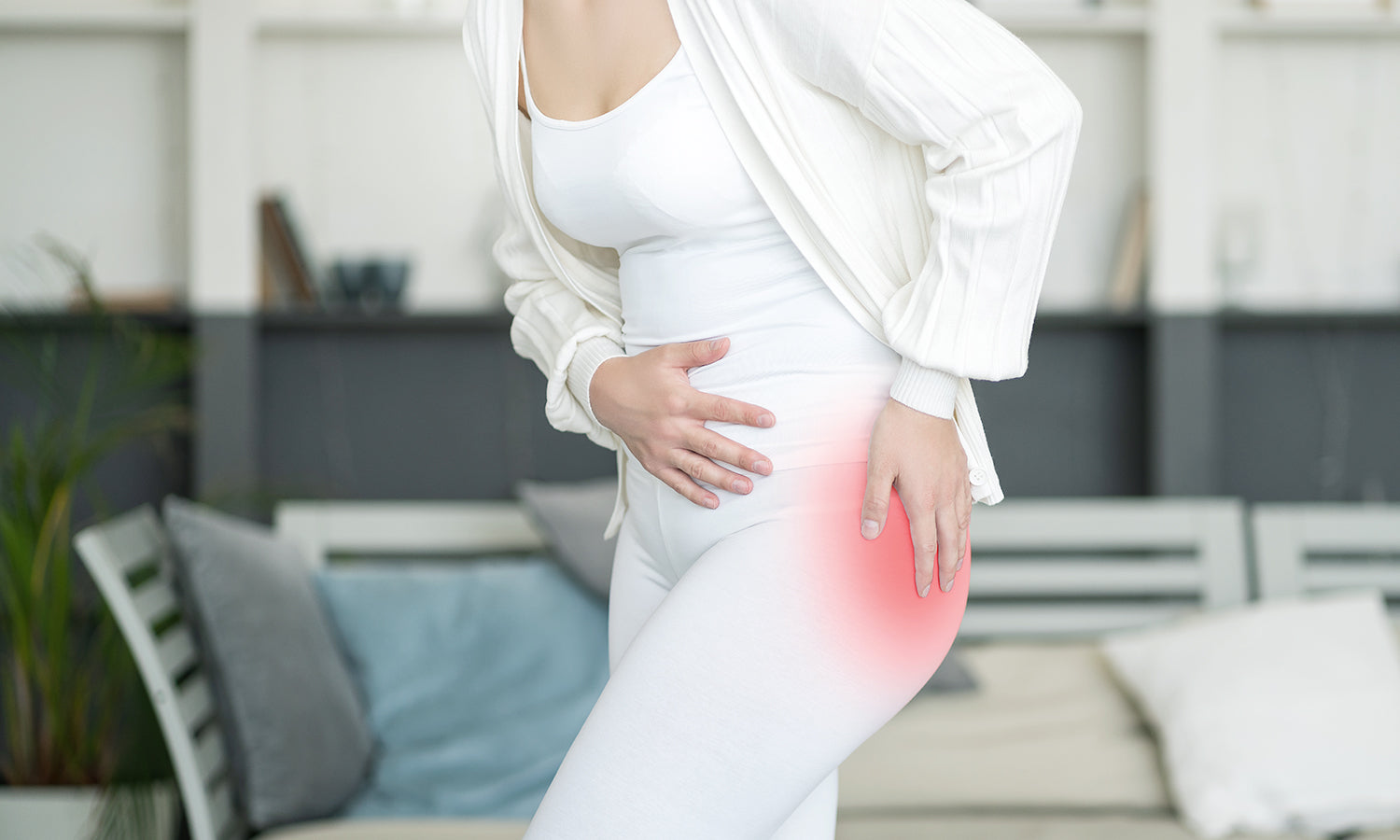 A woman holding her hip, experiencing severe pain from trochanteric bursitis