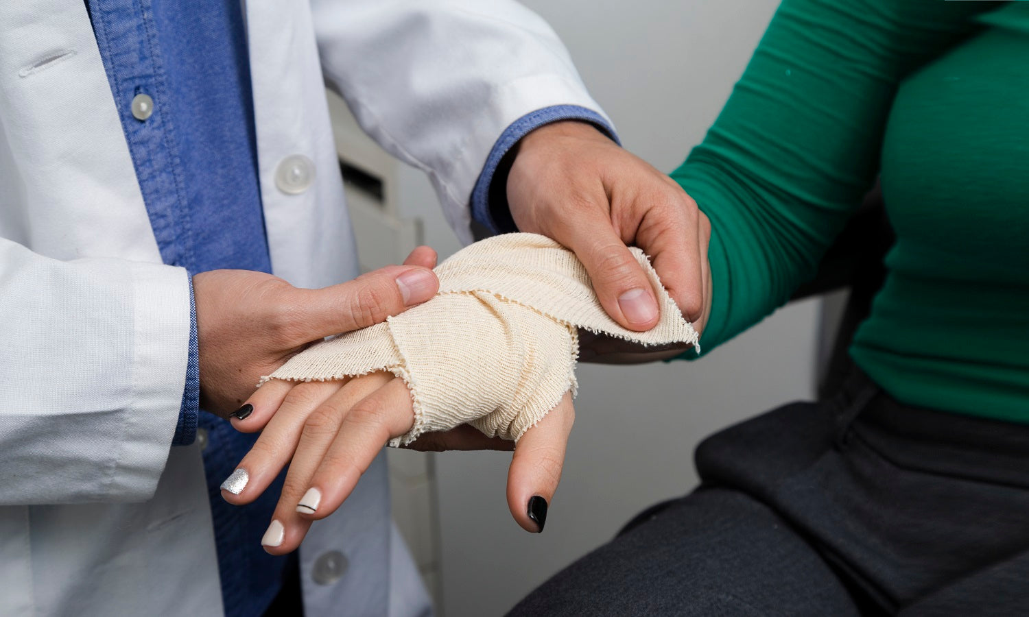 A person with an injured hand, having the wound dressed, considering PowerCure low-level laser therapy