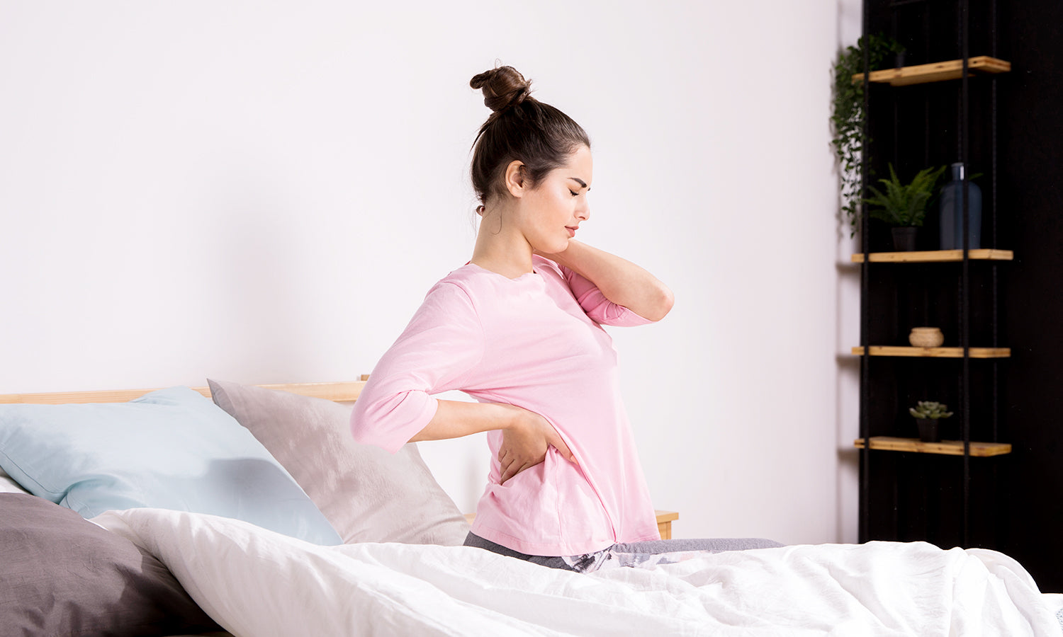 A woman holding her neck, experiencing discomfort from cervical disc herniation